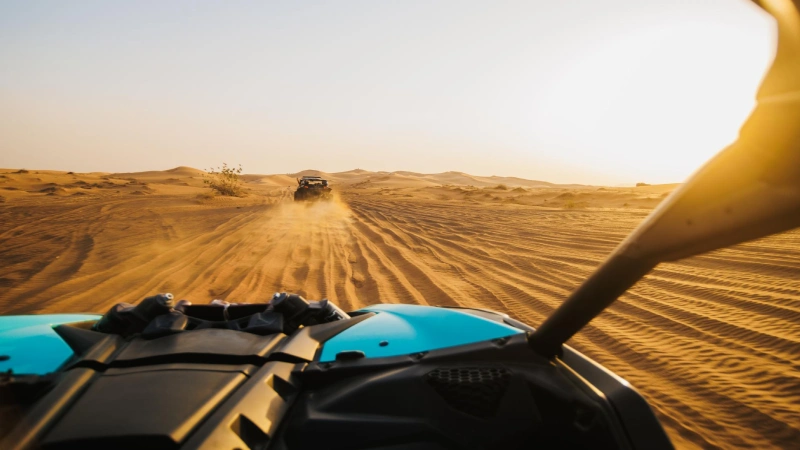 Dubai desert dune bashing and sandboarding 4x4 on steep sand dune sandboarder silhouette sunset | roamvisa.com