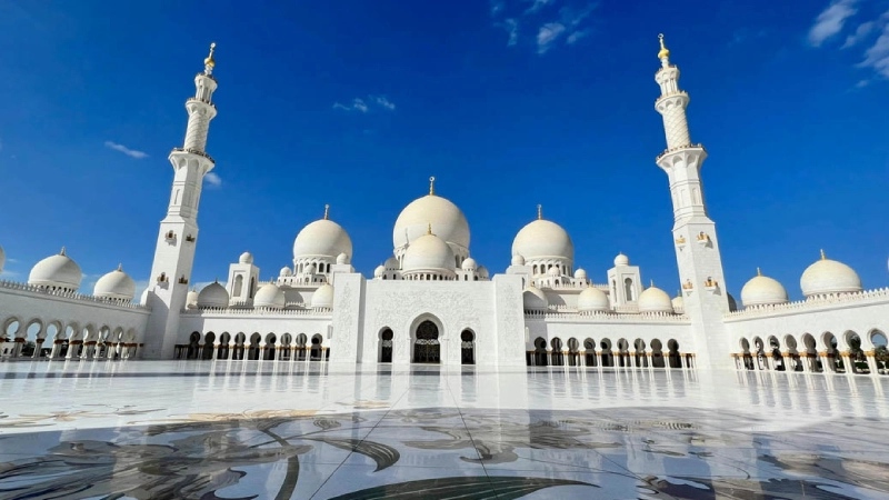 Morning view of Sheikh Zayed Grand Mosque Abu Dhabi with reflection pools and soft sunlight
