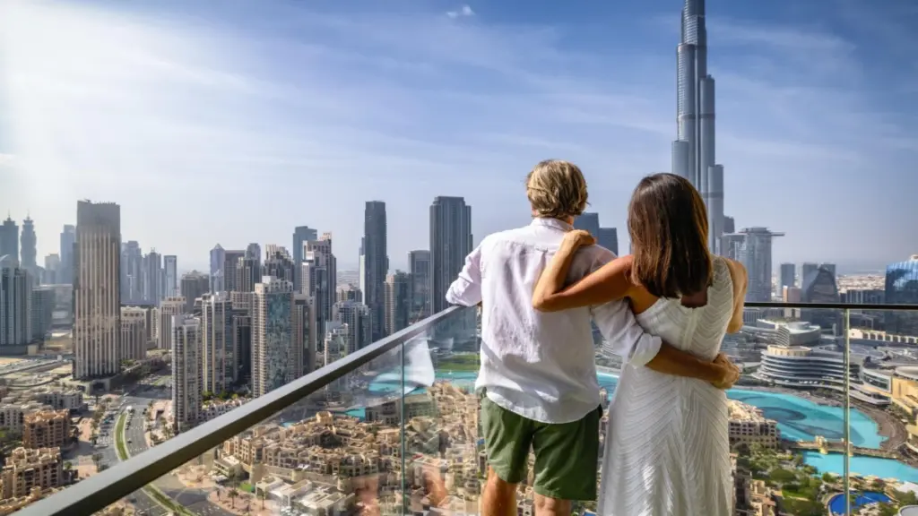 Dubai honeymoon experience desert camp candlelit dinner dunes couple starry night Arabian sky