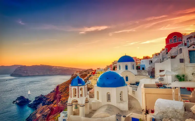 Visitors watching the famous Oia sunset in Santorini overlooking the caldera and Aegean Sea