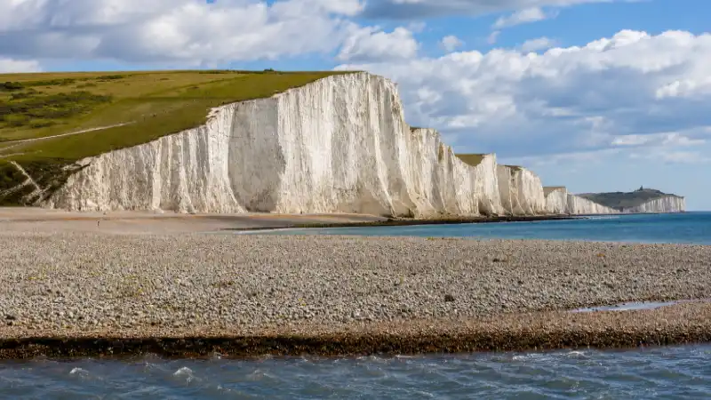Chalk cliffs of the Seven Sisters framing the beach at Cuckmere Haven in East Sussex