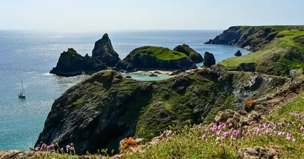 Best Beaches In The UK Turquoise water and serpentine rock stacks at Kynance Cove on Cornwall's Lizard Peninsula