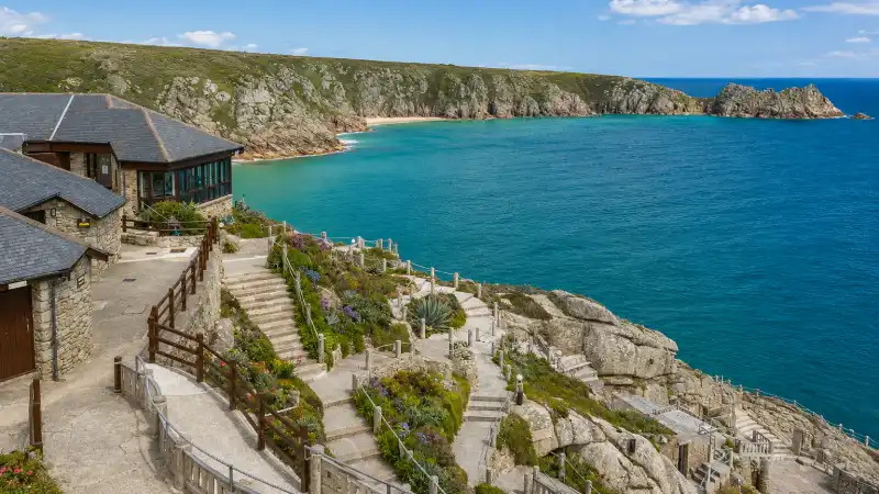 White-sand beach at Porthcurno, Cornwall, with the Minack Theatre carved into the clifftop