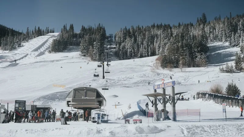 Snow covered ski slopes and mountain peaks surrounding the town of Aspen Colorado