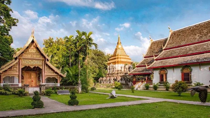 Buddhist monk walking through a temple courtyard in Chiang Mai Thailand