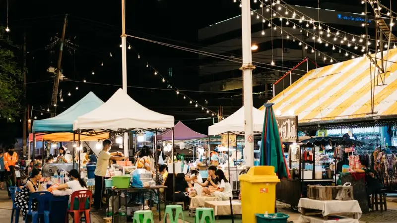 Family browsing stalls at a night market in Chiang Mai