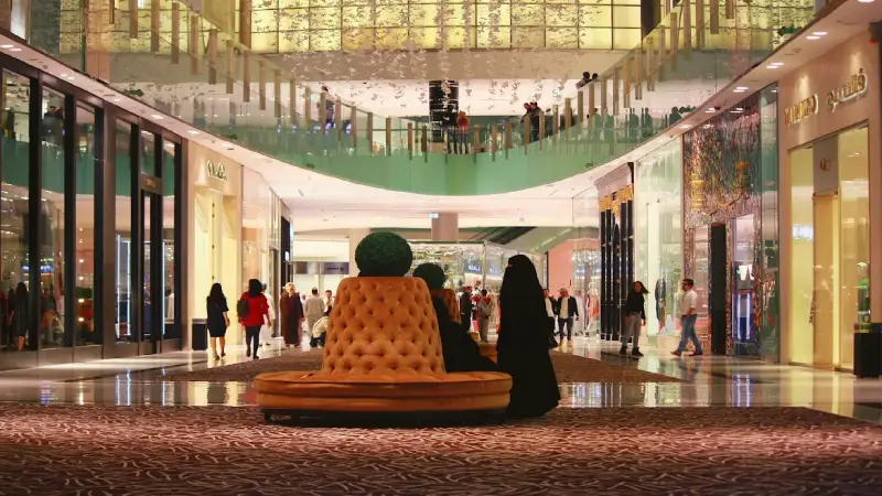 Interior view of Dubai Mall with shoppers and luxury storefronts