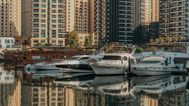 Dubai Marina skyline with boats along the waterfront 