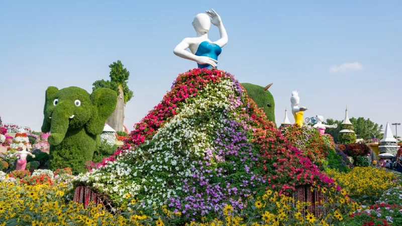 Family walking through colorful flower displays at Dubai Miracle Garden
