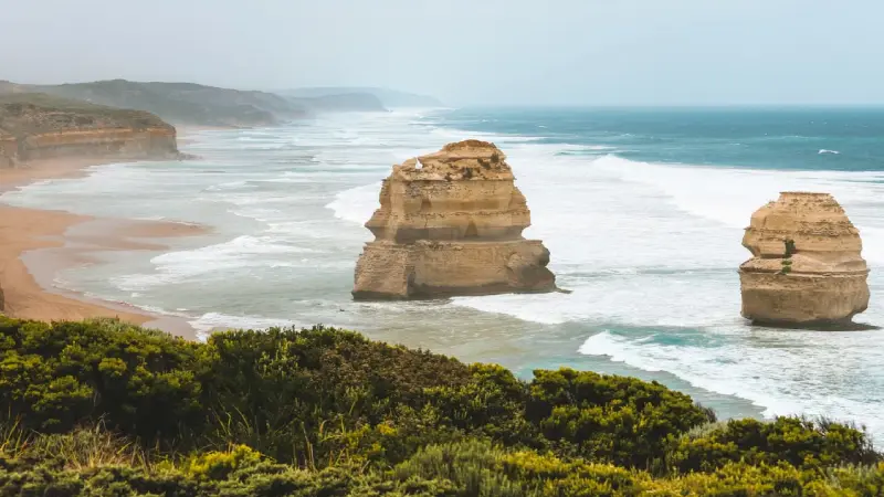 Family looking at the Twelve Apostles rock formations along the Great Ocean Road 