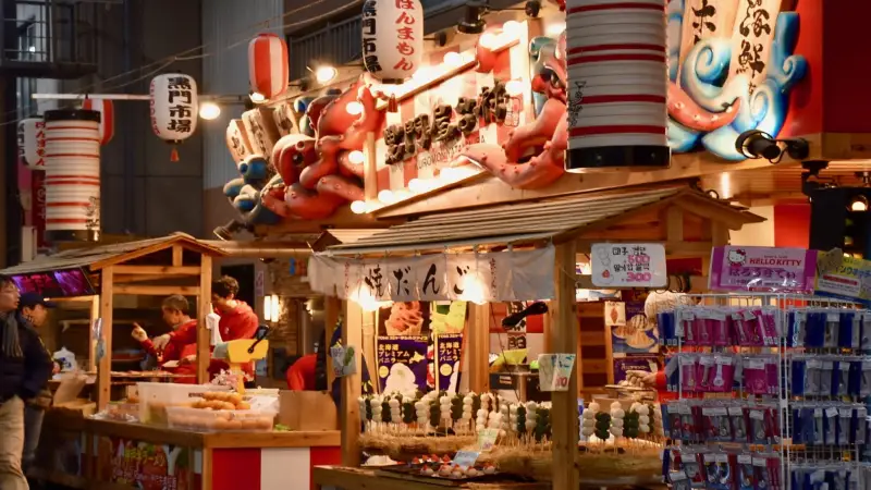 Vendors and street food stalls inside Kuromon Market in Osaka