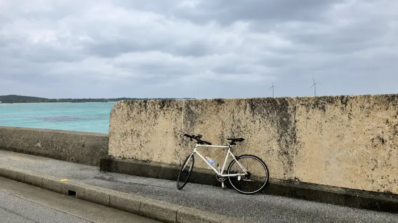 Cyclist riding along a coastal road on Miyako Island in Okinawa