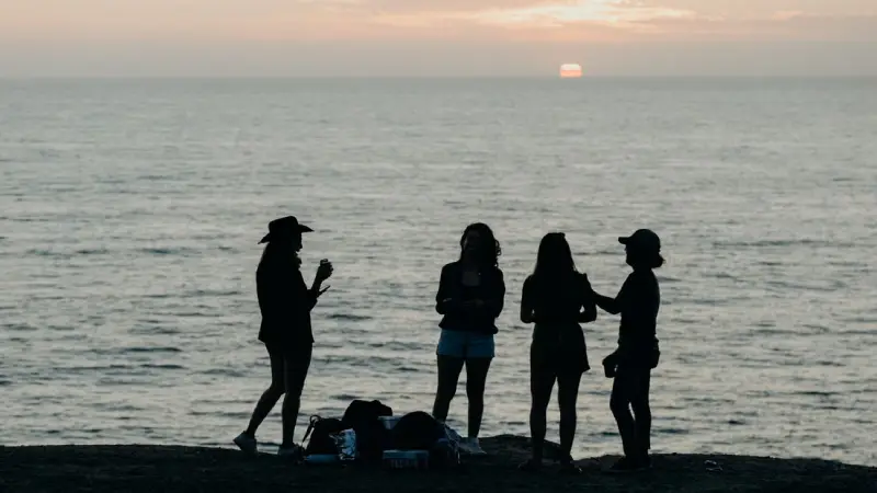 A family enjoying Coronado beach in San Diego at sunset 