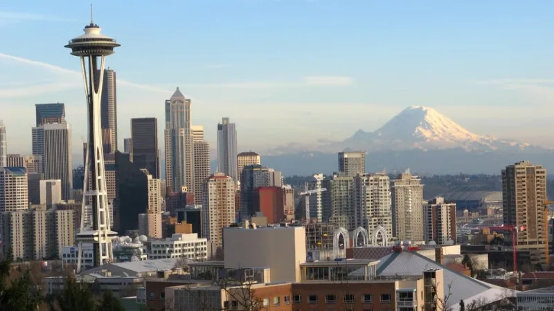 Seattle skyline with Mount Rainier visible in the background over Puget Sound