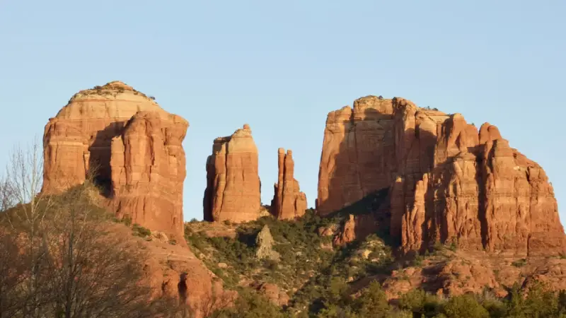 Cathedral Rock formation glowing red and orange at sunset in Sedona, Arizona