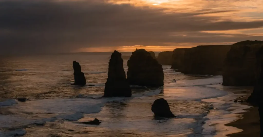 Twelve Apostles limestone rock formations along the Great Ocean Road at sunset