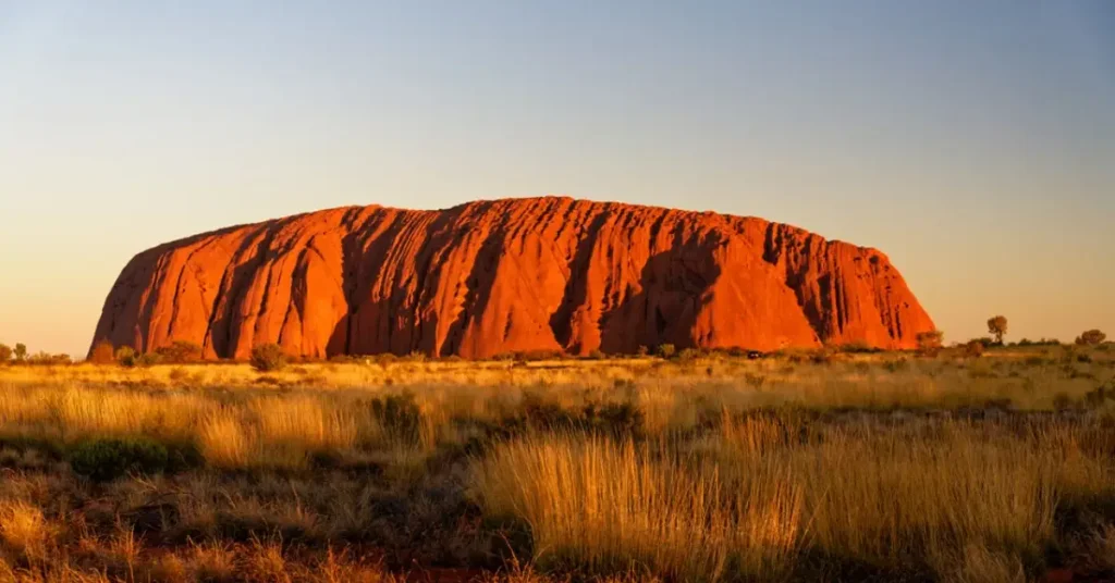 Uluru glowing red at sunset in the Australian outback and Most Beautiful Places in Australia