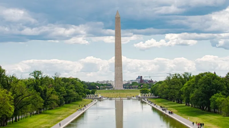 Family walking along the National Mall in Washington DC near the monuments