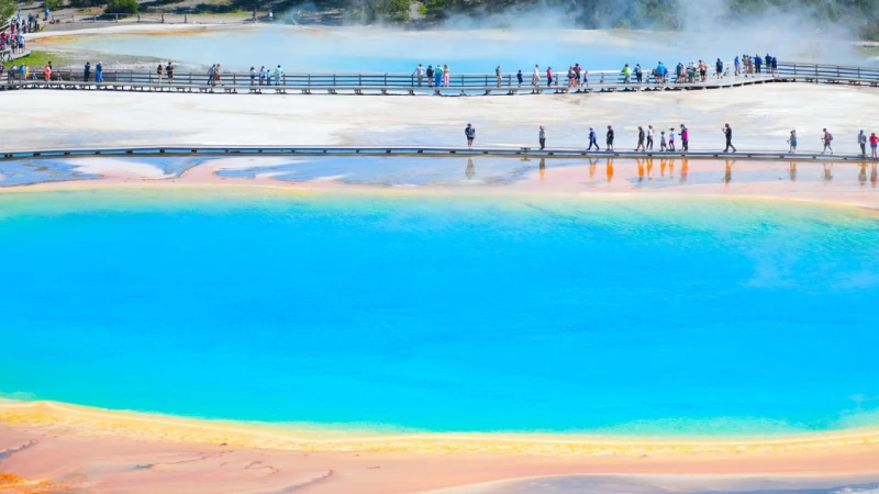 Family watching a geyser erupt at Yellowstone National Park