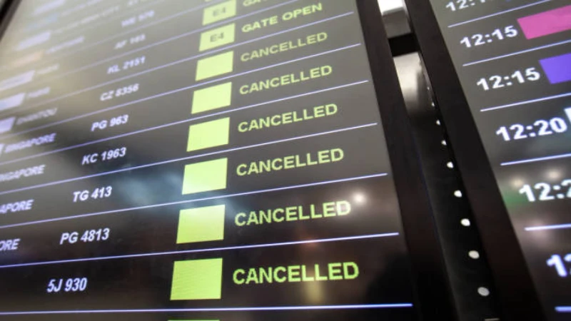 Flight cancellation notices displayed on an airport departure board