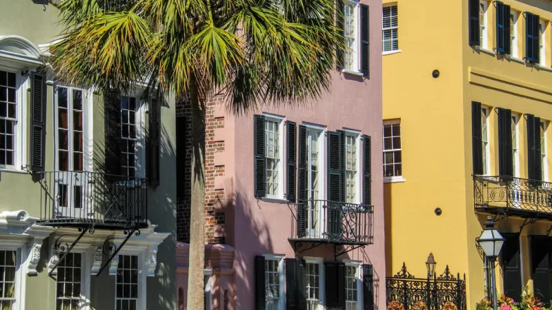 Colorful pastel historic houses lining a cobblestone street in Charleston South Carolina 