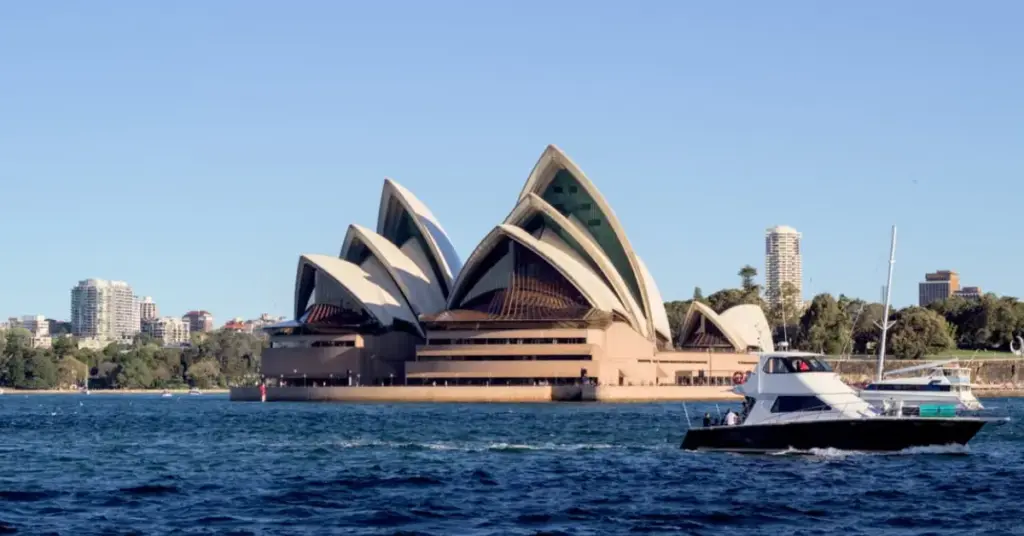Family looking out at the Sydney Opera House across the harbor. Family Trip To Australia