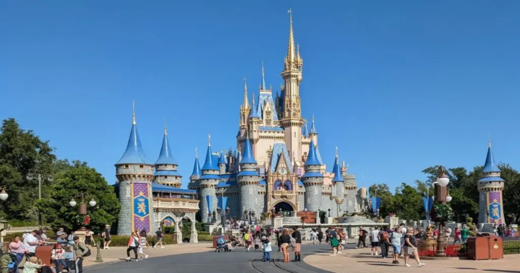 Family walking toward the castle at a Disney World theme park in Orlando