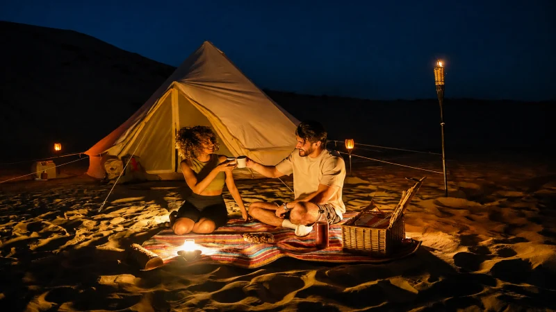 Couple enjoying a private desert camp setup during a honeymoon safari in Dubai