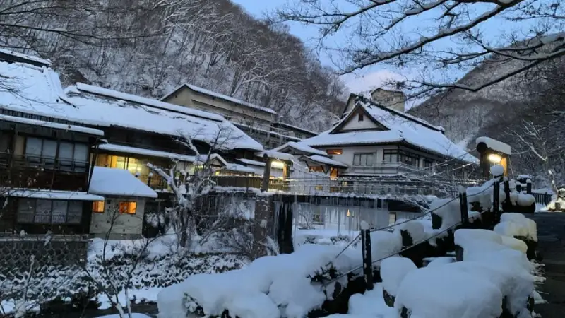Traditional Japanese onsen hot spring surrounded by snow near Hakuba