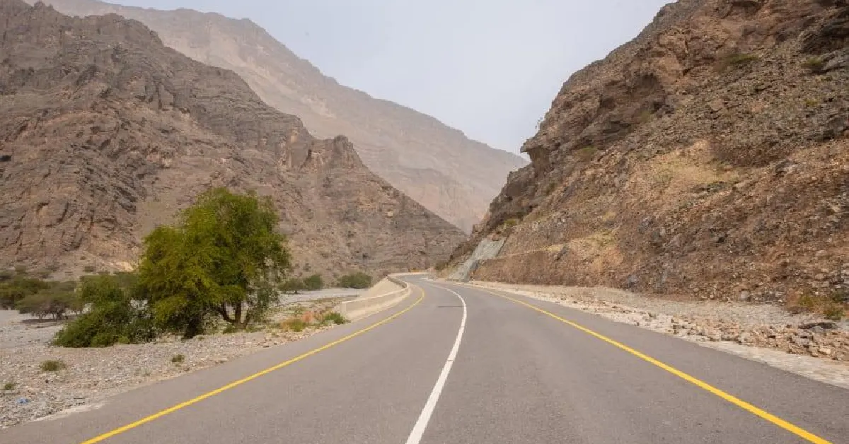 Dubai Road Trip To Oman and Car driving along a mountain road through the Hajar Mountains in Oman