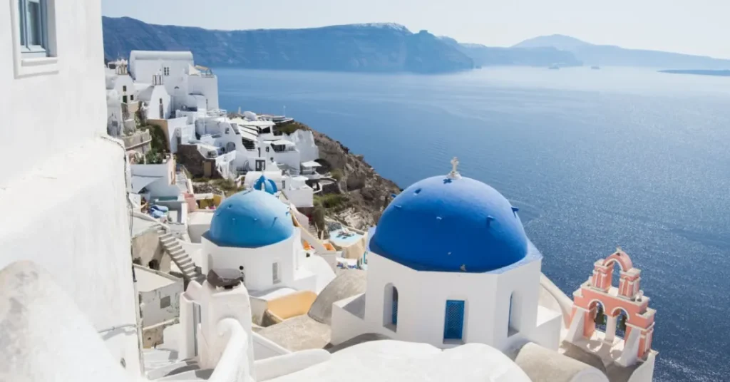 Whitewashed buildings and blue-domed churches in Oia, Santorini