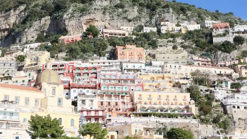 Pastel-colored houses stacked on the cliffside in Positano along the Amalfi Coast