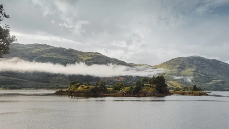 Misty mountains and loch in the Scottish Highlands