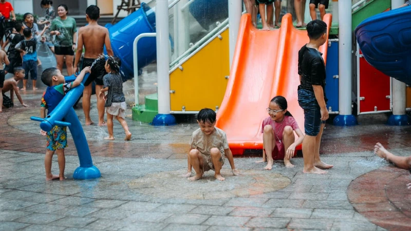 Children enjoying a water slide and splash pool 