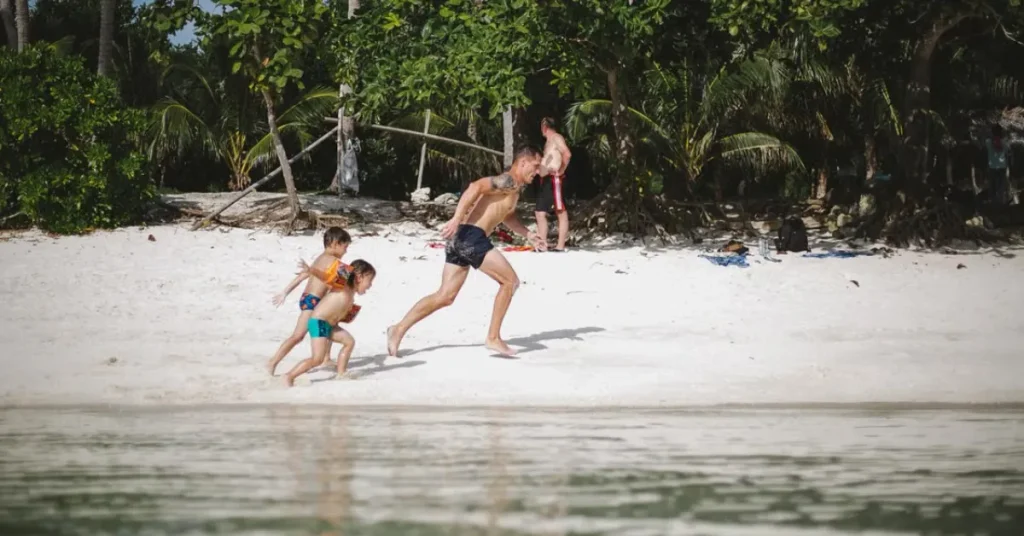 Phuket With Kids Best Things To Do Family playing together on a beach in Phuket, Thailand