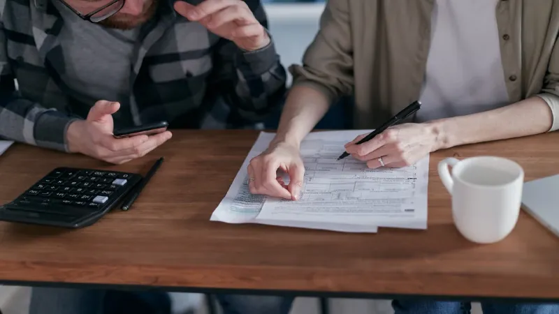 Family reviewing travel insurance documents together on a laptop