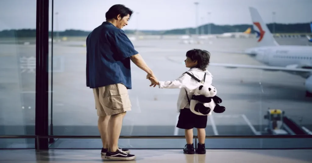 Best Family Travel Insurance USA. Family with young children walking through an airport with luggage