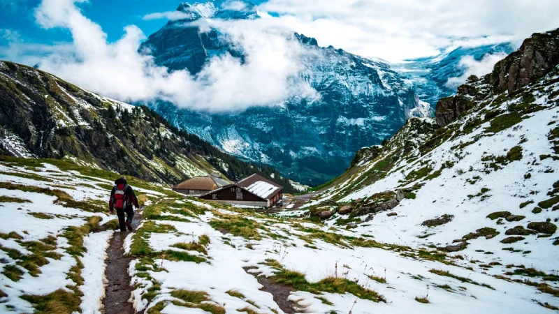 Hiker walking through the Alps mountains in Switzerland