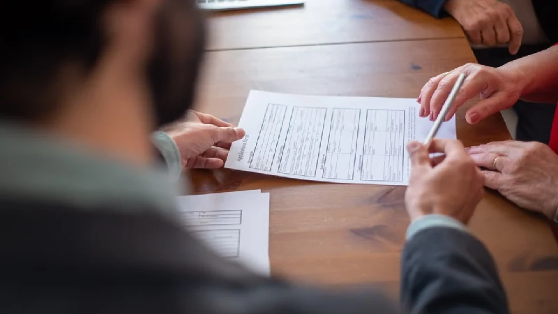 Insurance policy documents laid out for comparison on a table