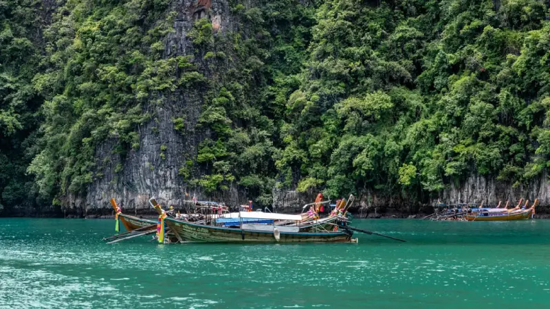 Longtail boat cruising through Phang Nga Bay in Thailand