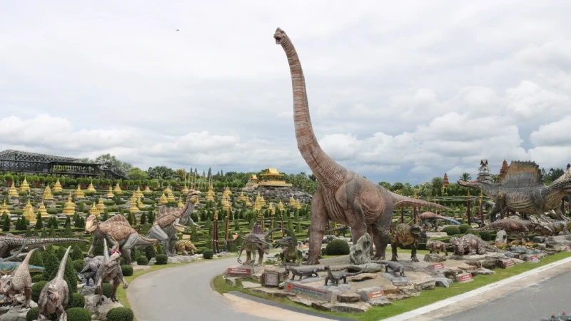 Dinosaur themed mini golf course with life-sized dinosaur statues