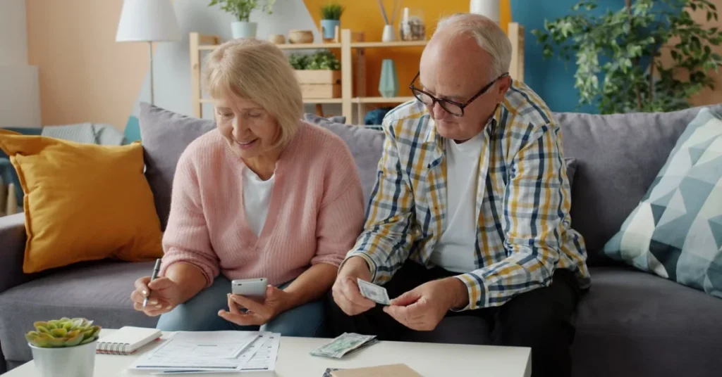 Senior couple reviewing insurance documents while planning a trip