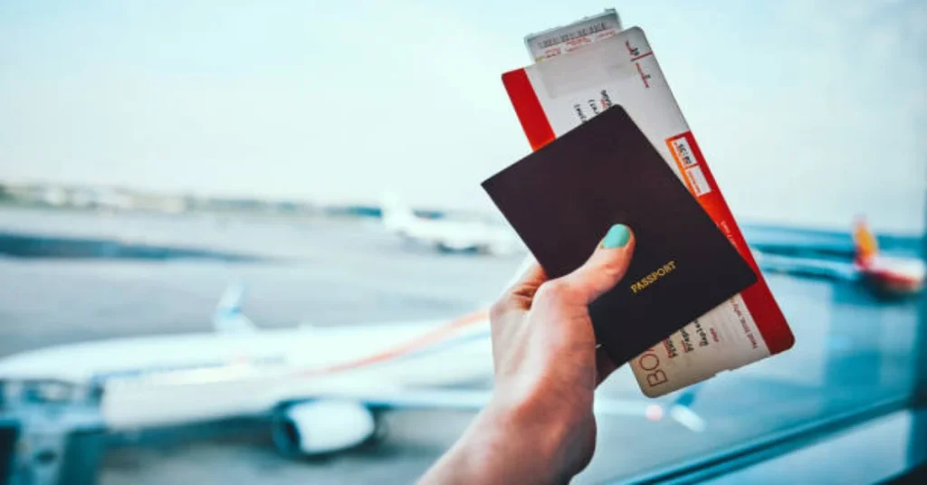 Best Schengen Visa Travel Insurance traveler holding passport and boarding pass at airport with Europe map background