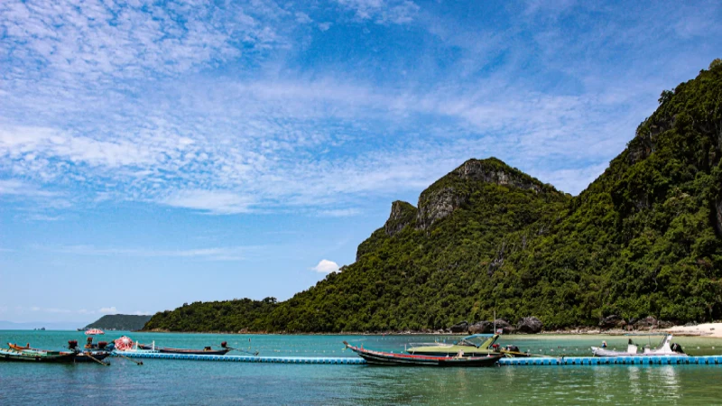 A boat cruising through the limestone islands of Ang Thong Marine Park near Koh Samui