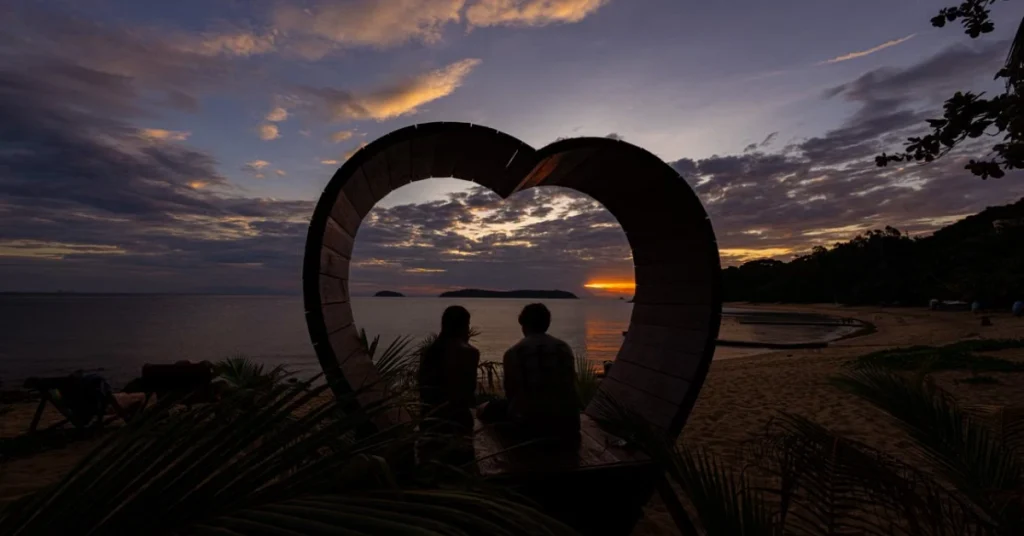 Koh Samui Couples Holiday Guide A couple watching the sunset on a quiet beach in Koh Samui