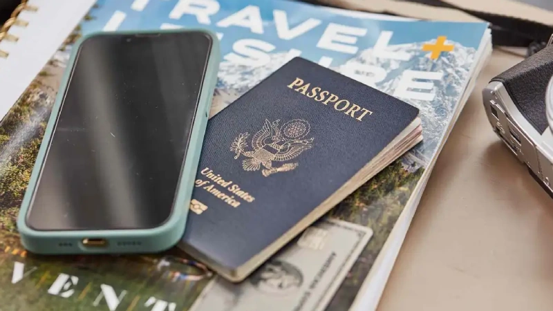A traveller scanning a passport with a smartphone during an online travel application